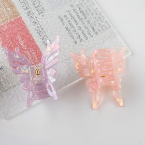 Set of two iridescent butterfly hair claws in pastel purple and orange pink colors