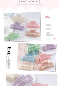 Detail of colorful marble textured hair claws in Morandi tones with matte finish