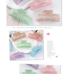 Macro shot of rectangular acetate hair claws in pastel marble textures and colors