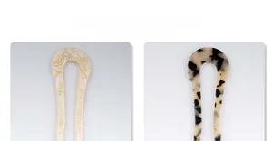 Close-up of U-shaped acetate hair pins in marble cream and tortoise shell patterns