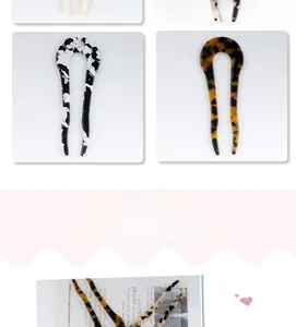 Detailed view of U-shaped acetate hairpins in tortoiseshell and ink marble patterns