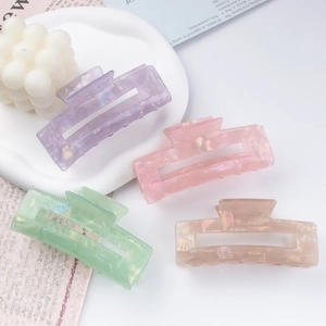 Set of four large matte marble pattern hair claw clips in pastel candy colors for women
