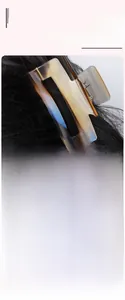 Detail view of large marbled amber acetate hair claw clip on long black wavy hair