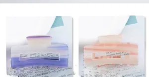 Detail of gradient acetate rectangular hair claws in purple and peach orange finishes