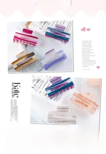 Detail view of striped rectangle hair claw clips in various colors with metallic springs