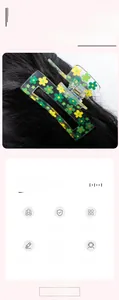 Detailed macro view of the rectangular clover hair claw clip with floral patterns