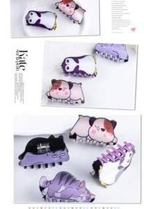 Detail of colorful animal-shaped hair claws featuring cute cat, dog, and penguin designs