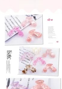 Detailed views of acetate shark hair clips with pink floral and marble patterns