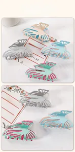 Close-up of glittery hollow butterfly hair claws in various metallic color combinations