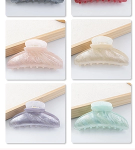 Detail view showing variety of large pastel acetate hair claws in multiple colors