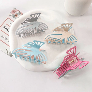 Pack of four glitter butterfly hair claws in silver pink blue and magenta colors
