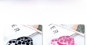 Detail view of cow print heart sun hat hair clips with metallic spring fastener