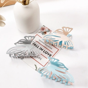 Glitter butterfly hair claws set in silver and champagne gold on a clean white background