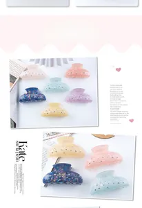 Detail view of multi-colored acrylic hair claws with shiny rhinestones in pastel tones
