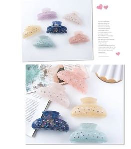 Detailed close-up of colorful acetate hair claws with sparkling rhinestone accents