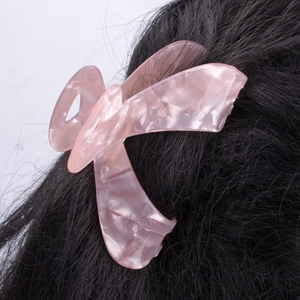 Pink marble pattern butterfly hair claw clip for women on long black straight hair