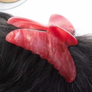 Minimalist red butterfly acrylic hair claw with marble texture and gold glitter