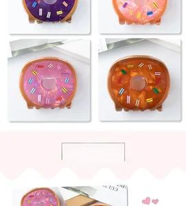 Detailed view of colorful handmade donut hair claws with glitter finish and sprinkle accents