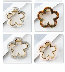Detail view of hollow flower hair claws in four colors with gold metal edge and strong spring