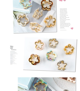 Close-up of floral hair claws in pink and marble patterns with gold metal springs