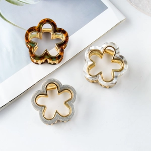 Three-piece floral hair claw clips in amber, pearl white, and silver glitter finishes