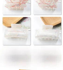 Detailed view of cream acetate hair claw clip featuring Cupid and Valentine's Day engraving