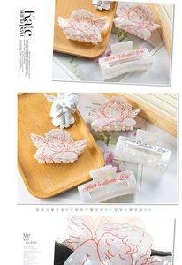 Detail of angel-shaped hair claw and rectangle Happy Valentine's Day hair clip