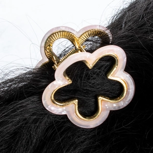 Pink floral hair claw clip with golden metal frame and pearlescent acrylic finish