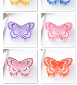 Detail view of 8cm butterfly hair claws featuring multi-color layered ripple patterns