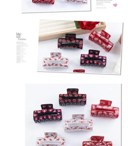 Detail of red heart and lip pattern acrylic hair claws for Valentine's Day styling
