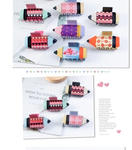 Detailed view of pencil-shaped Valentine's Day hair clips with heart patterns
