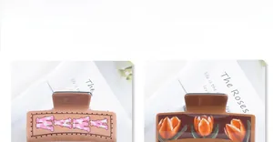 Detail of square hair claws with cow print MAMA letters and orange tulip patterns