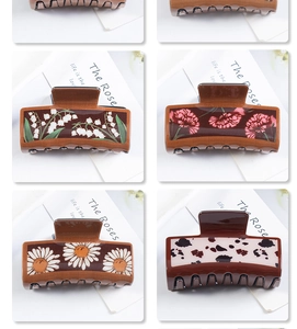 Detailed views of vintage square hair claws featuring rose, lily, and cow print designs