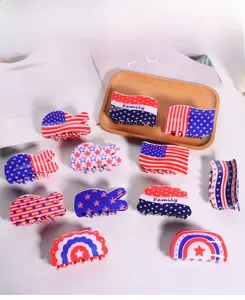 Flat lay of diverse American flag pattern hair claws and patriotic shark clips on white