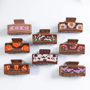 Set of eight floral pattern hair claw clips featuring daisy, tulip and mama lettering