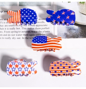 Detail view of five V-shaped American flag hair claws with red white and blue patterns