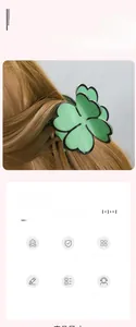 Detail of light green clover hair claw clip showing glossy resin finish on brown hair