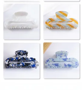 Detail showing rectangular cutout hair claws in four colors including marble and stripes