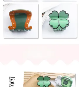 Detailed close-up of lucky four-leaf clover hair claw clip with colorful resin patterns