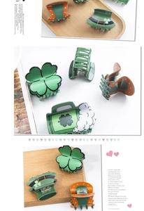Detail view of festive St. Patrick's Day themed hair claws with clover and hat designs