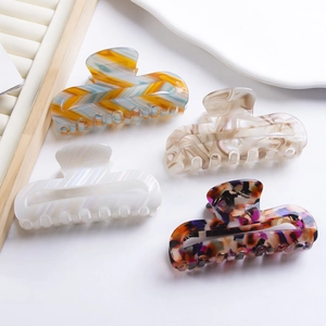 Set of four stylish rectangular hollow hair claw clips in diverse marble and floral patterns