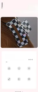 Detail of checkered hair claw clip with black and white patterns and glossy finish