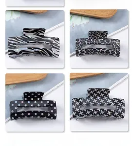 Detail of checkered and animal print hair claws in zebra, leopard, and polka dot patterns