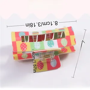 Detail view of 8.1cm Easter checkerboard square hair claw clip with colorful egg patterns