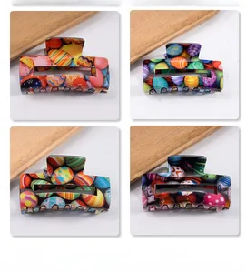 Detailed view of square hair claws with colorful Easter egg patterns and patterns