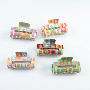 Set of 5 colorful Easter egg pattern square PVC hair claws on a clean white background