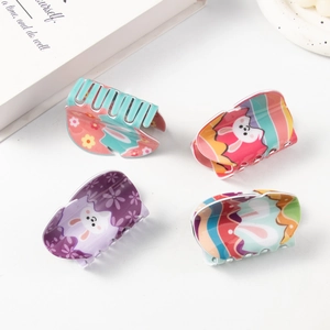 Set of four cute cartoon Easter bunny hair claw clips in pastel purple and pink colors