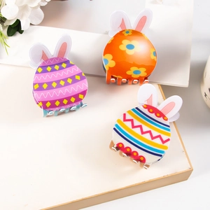 Three colorful floral bunny hair claws in purple, orange and striped acrylic patterns