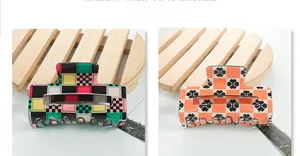 Close-up of square checkered claw clips with colorful patterns and floral accents