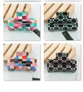 Macro shot of rectangular checkerboard claw clips with floral and geometric patterns